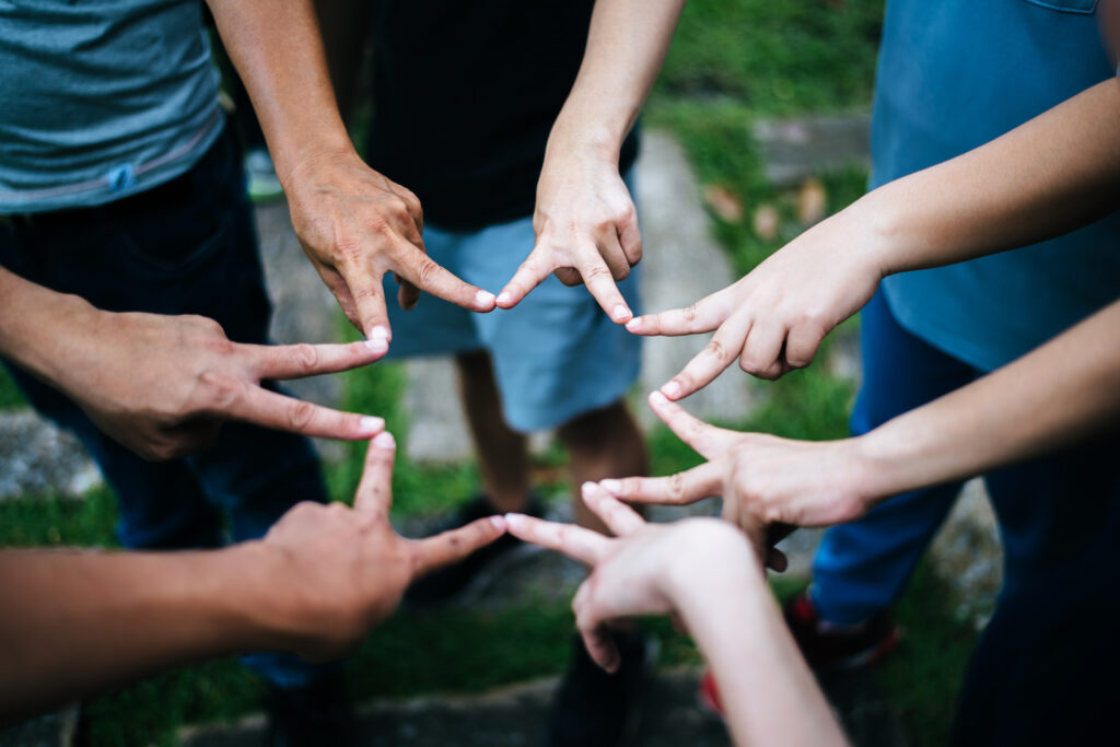 Women and men friends make star shape from fingers. Success, fri
